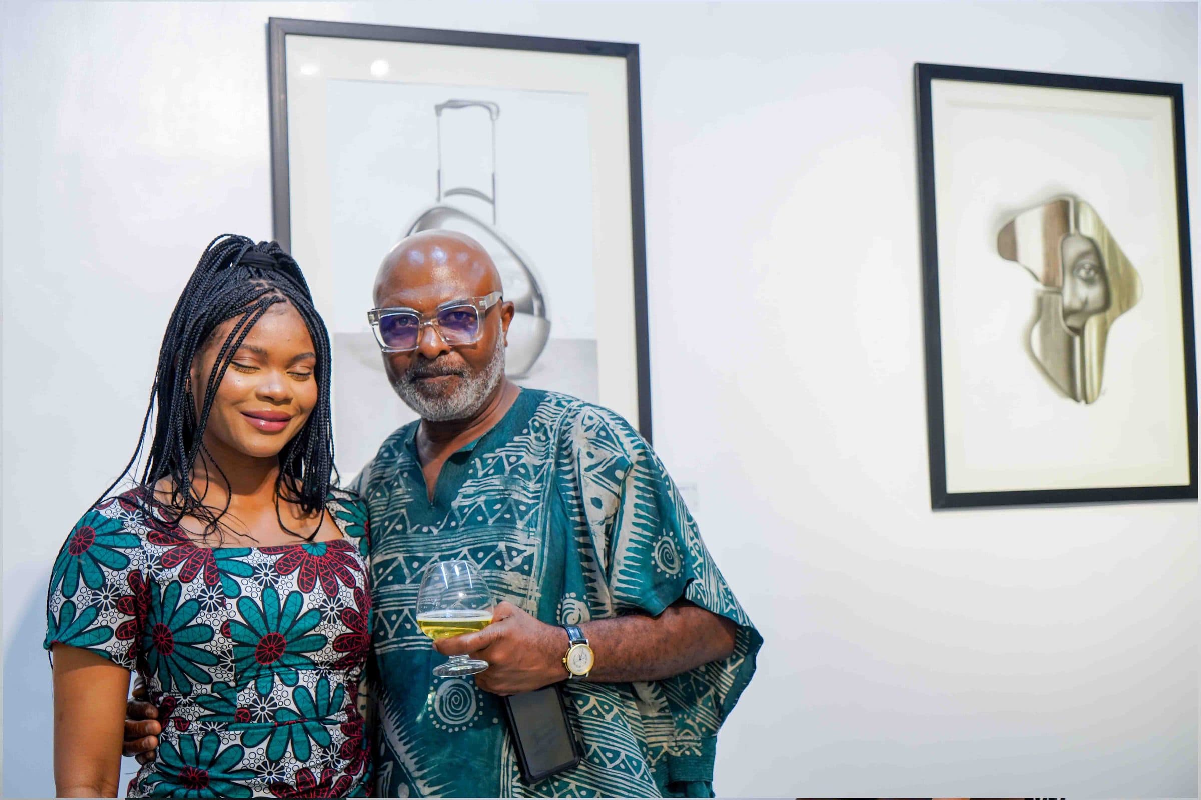 Two guests smiling in front of the works