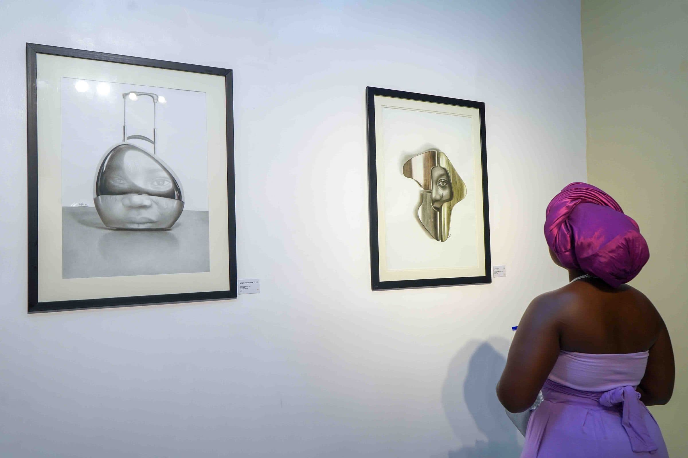 A visitor in a purple head wrap views the works