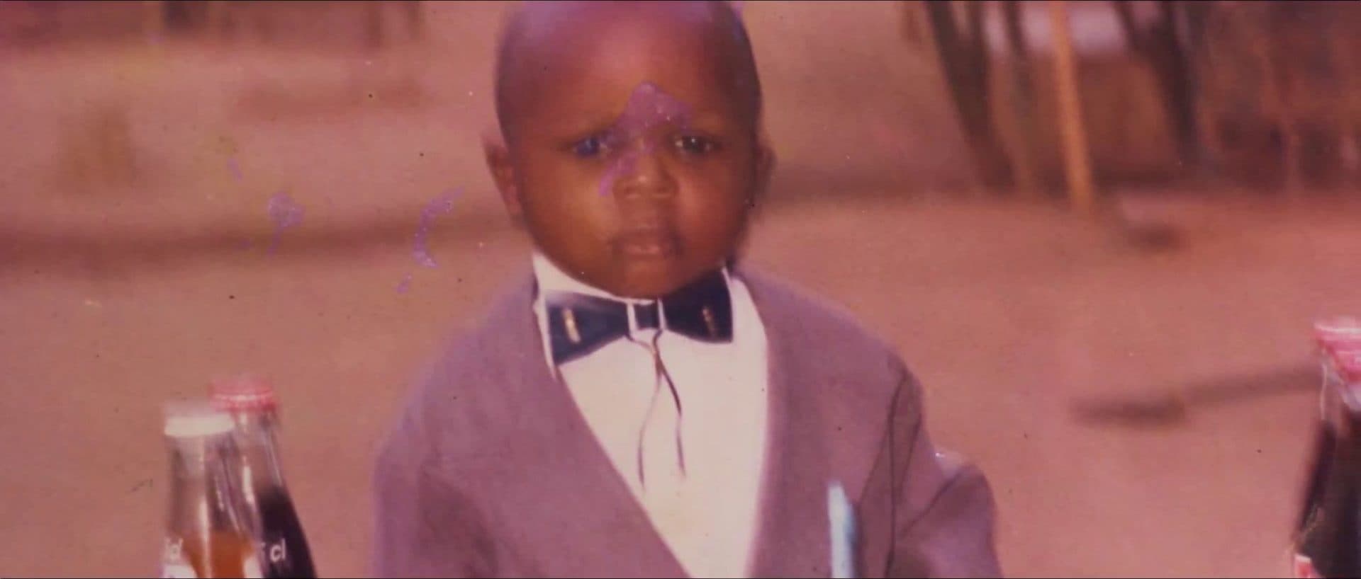 A childhood photograph of Fatola in a bow tie
