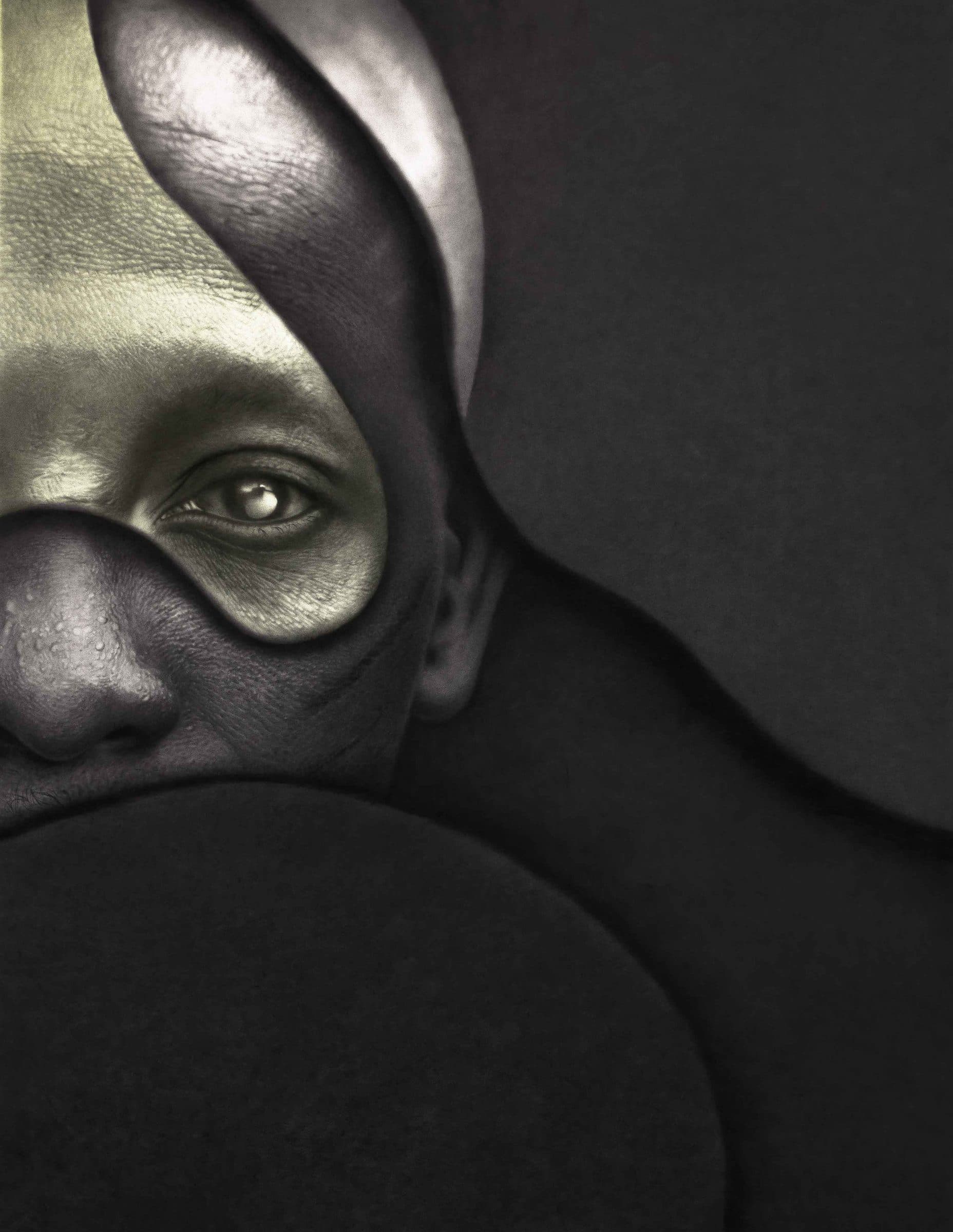 Large charcoal portrait with a subtle facial marking